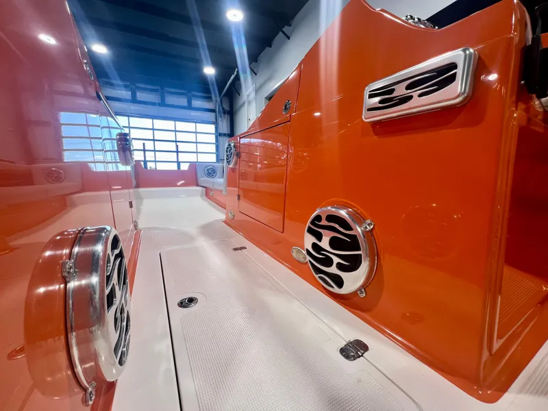 Slide: The Image of 2008 Shockwave Fundeck boat interior with vibrant orange finish and stylish speaker grills. - 22