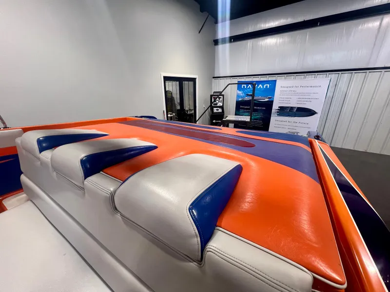 Slide: The Image of 2008 Shockwave Fundeck boat interior with vibrant orange and blue upholstery. - 23