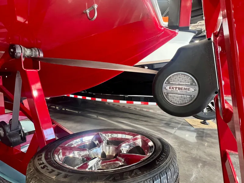 Slide: The Image of Red 2008 Shockwave Fundeck boat on trailer with chrome wheel and Extreme logo. - 8