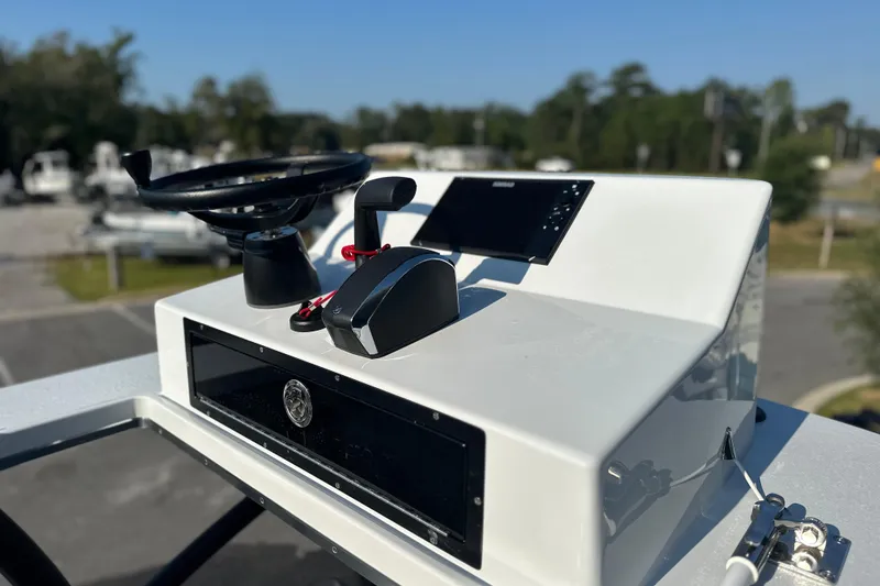 Slide: The Image of 2025 East Cape 25 Open boat console with steering wheel and controls. - 18