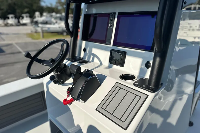 Slide: The Image of 2025 East Cape 25 Open boat dashboard with steering wheel and navigation screens. - 19
