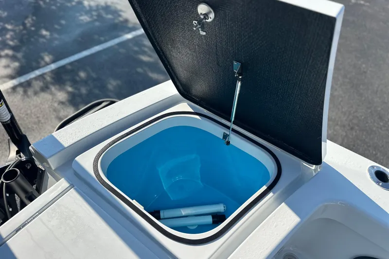 Slide: The Image of Open storage compartment on 2025 East Cape 25 Open boat, featuring a blue interior. - 20
