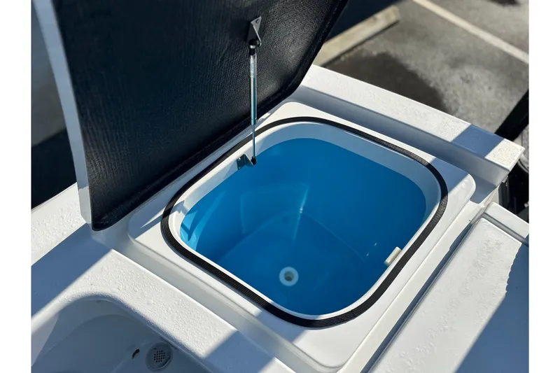 Slide: The Image of Open storage compartment on 2025 East Cape 25 Open boat, featuring a blue interior. - 22