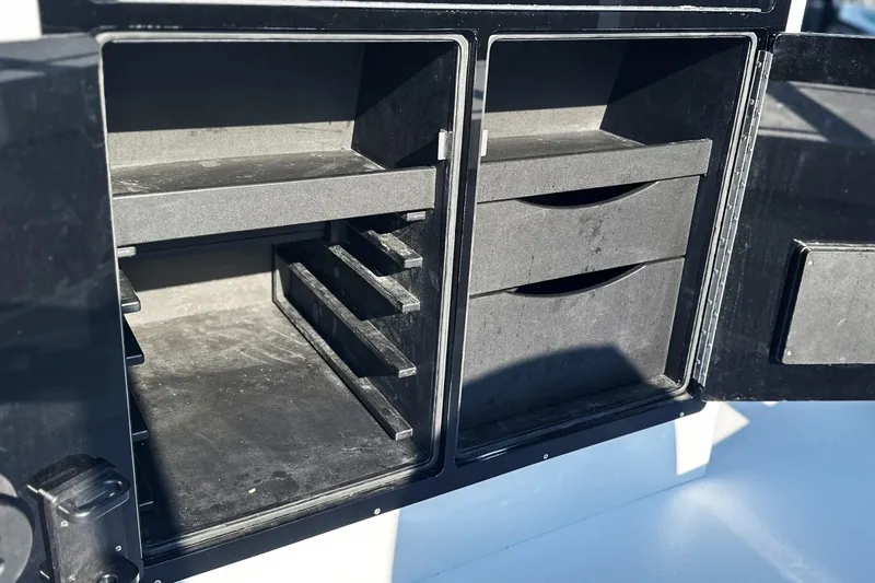 Slide: The Image of Open storage compartments on a 2025 East Cape 25 Open boat. - 23