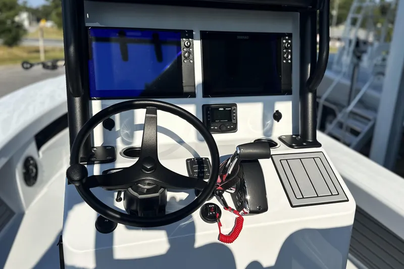 Slide: The Image of 2025 East Cape 25 Open boat console with steering wheel and navigation screens. - 24