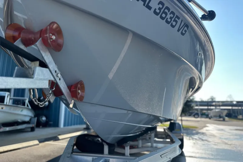 Slide: The Image of 2025 East Cape 25 Open boat on trailer, close-up view of hull and rollers. - 28