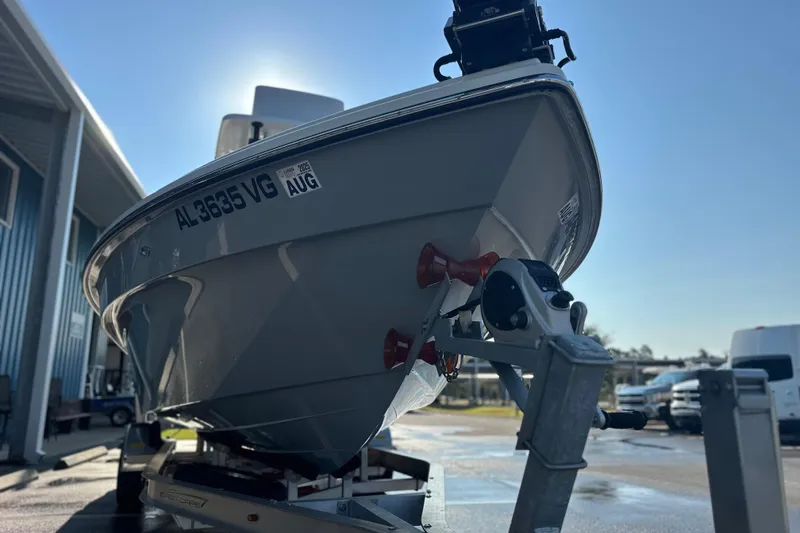 Slide: The Image of 2025 East Cape 25 Open boat on trailer, parked outdoors under clear sky. - 29