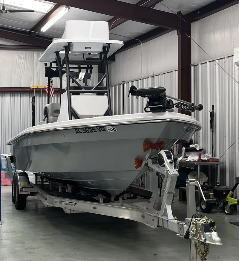Slide: The Image of 2025 East Cape 25 Open boat on trailer in a garage setting. - 3