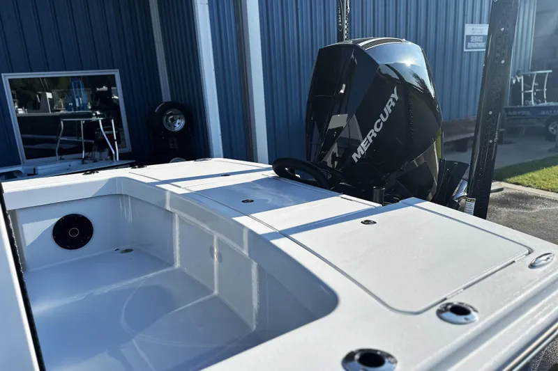 Slide: The Image of 2025 East Cape 25 Open boat with Mercury engine, docked near blue building. - 34