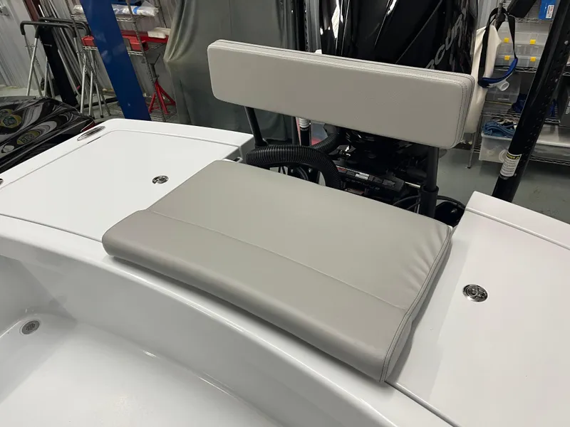 Slide: The Image of 2025 East Cape 25 Open boat seat with cushioned backrest in a workshop setting. - 4