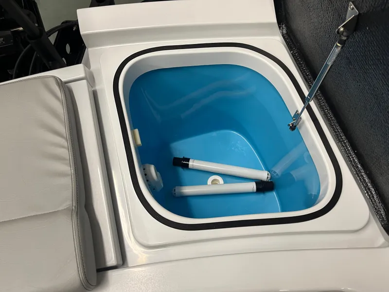 Slide: The Image of 2025 East Cape 25 Open boat livewell with blue interior and white lid. - 6