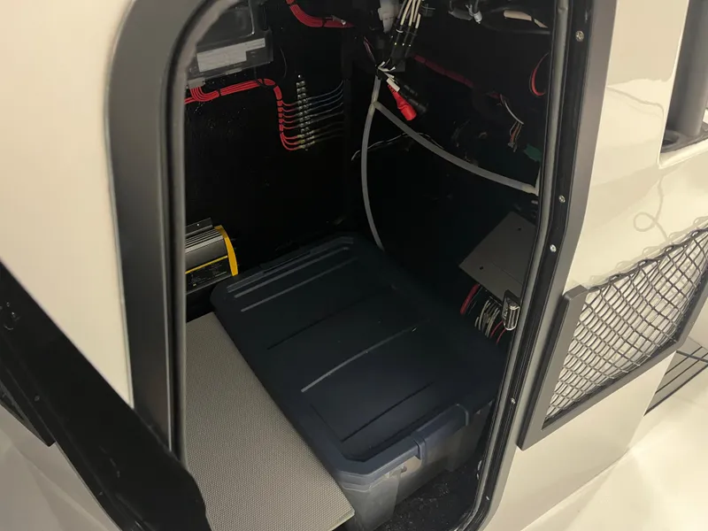 Slide: The Image of Interior view of 2025 East Cape 25 Open boat storage compartment with wiring and equipment. - 9