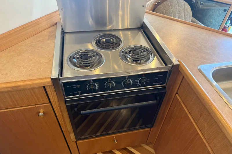 Slide: The Image of Stove and oven in 2000 Bayliner 3988 Command Bridge Motoryacht kitchen area. - 14