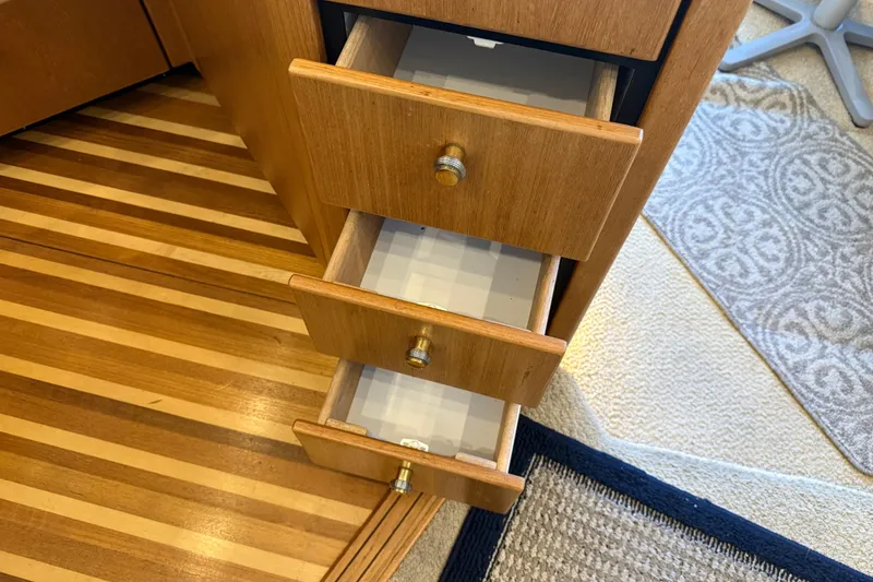 Slide: The Image of Open wooden drawers inside a 2000 Bayliner 3988 Command Bridge Motoryacht, showcasing interior design. - 17