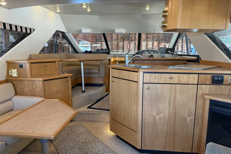Slide: The Image of Interior of 2000 Bayliner 3988 Command Bridge Motoryacht with wood cabinetry and seating area. - 2