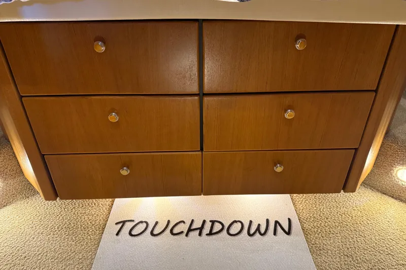 Slide: The Image of Wooden drawers on Bayliner 3988 yacht, 2000 model, with "TOUCHDOWN" mat. - 28