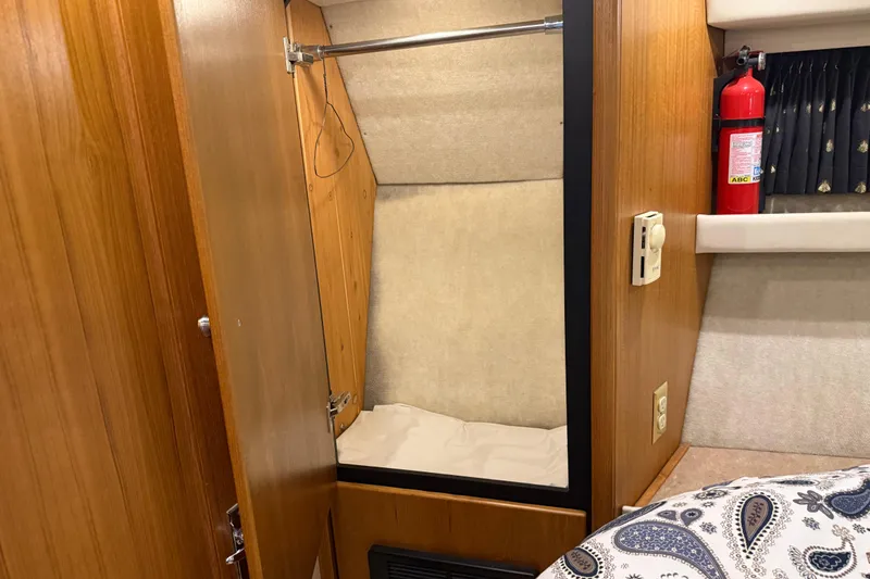 Slide: The Image of 2000 Bayliner 3988 Command Bridge Motoryacht interior with closet and fire extinguisher. - 33