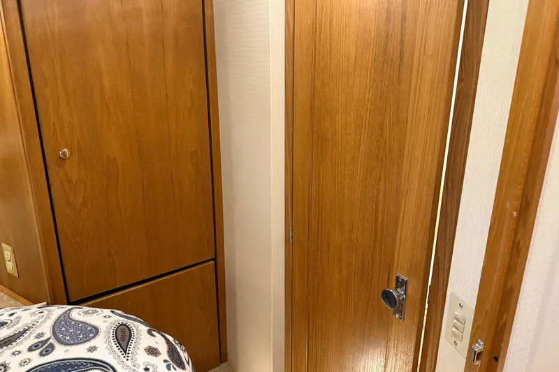 Slide: The Image of Wooden interior of 2000 Bayliner 3988 Command Bridge Motoryacht with paisley-patterned bedding. - 35