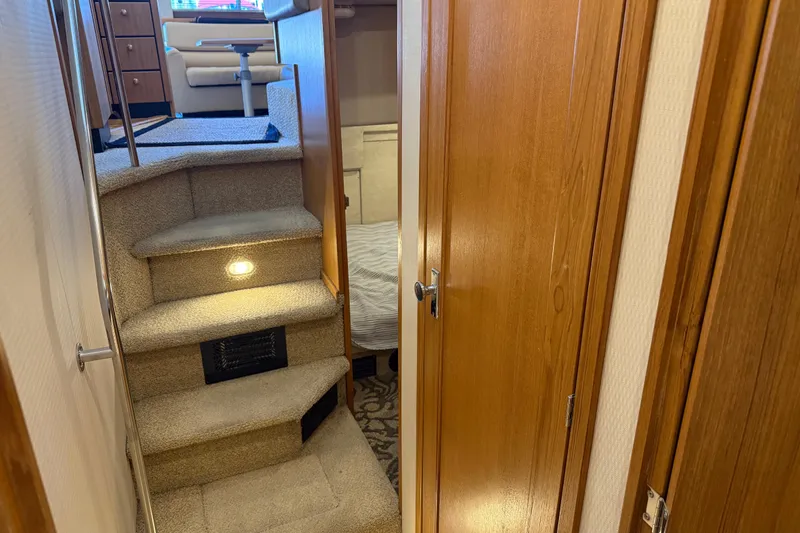 Slide: The Image of Interior of 2000 Bayliner 3988 Command Bridge Motoryacht with carpeted stairs and wooden doors. - 40