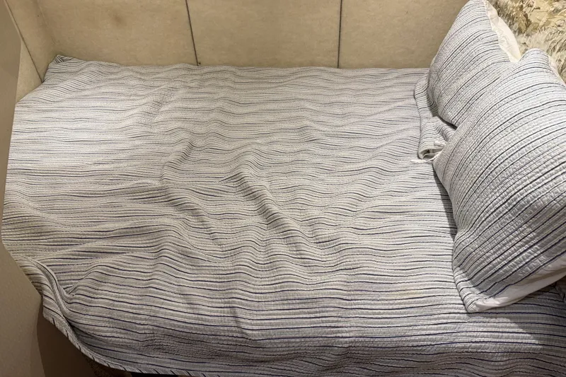 Slide: The Image of Cozy bed with striped bedding in 2000 Bayliner 3988 Command Bridge Motoryacht cabin. - 42