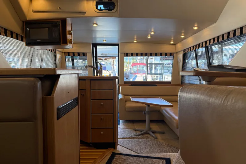 Slide: The Image of Interior of 2000 Bayliner 3988 Command Bridge Motoryacht with modern kitchen and seating area. - 49