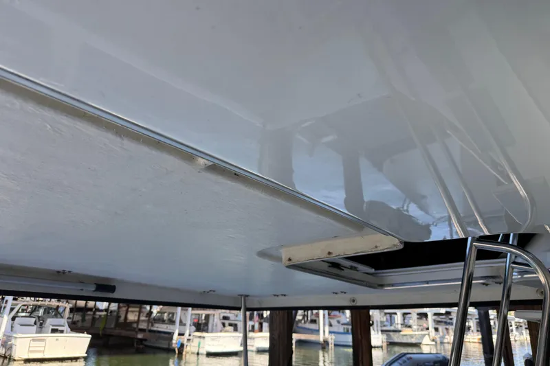 Slide: The Image of 2000 Bayliner 3988 Command Bridge Motoryacht, marina view, partial deck and ladder. - 50