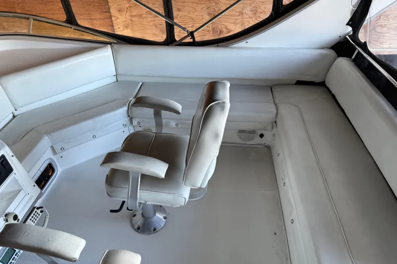 Slide: The Image of 2000 Bayliner 3988 Command Bridge Motoryacht interior with white seating and helm chair. - 55