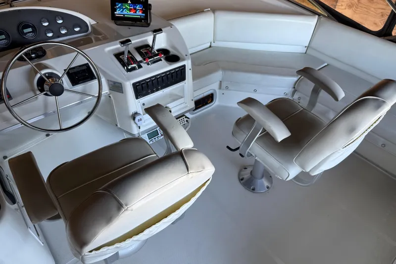 Slide: The Image of 2000 Bayliner 3988 Command Bridge Motoryacht helm with dual seats and navigation controls. - 56