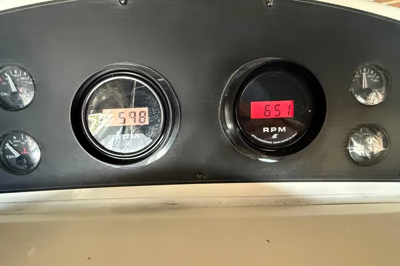 Slide: The Image of Dashboard of 2000 Bayliner 3988 Command Bridge Motoryacht showing RPM gauges. - 59