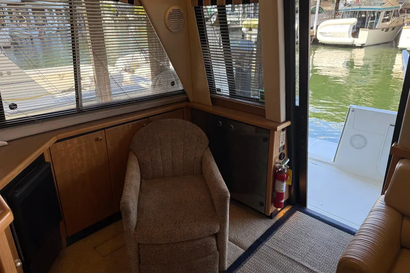 Slide: The Image of Interior of 2000 Bayliner 3988 Command Bridge Motoryacht with chair, window, and open door to deck. - 6