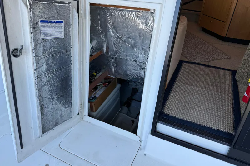 Slide: The Image of 2000 Bayliner 3988 Command Bridge Motoryacht interior with open hatch and storage area. - 64