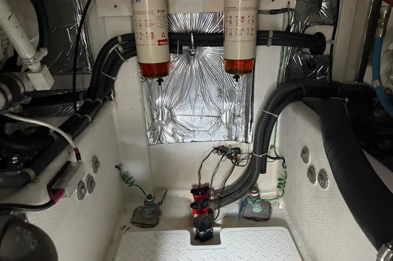Slide: The Image of Engine room of 2000 Bayliner 3988 Command Bridge Motoryacht with fuel filters and wiring. - 69