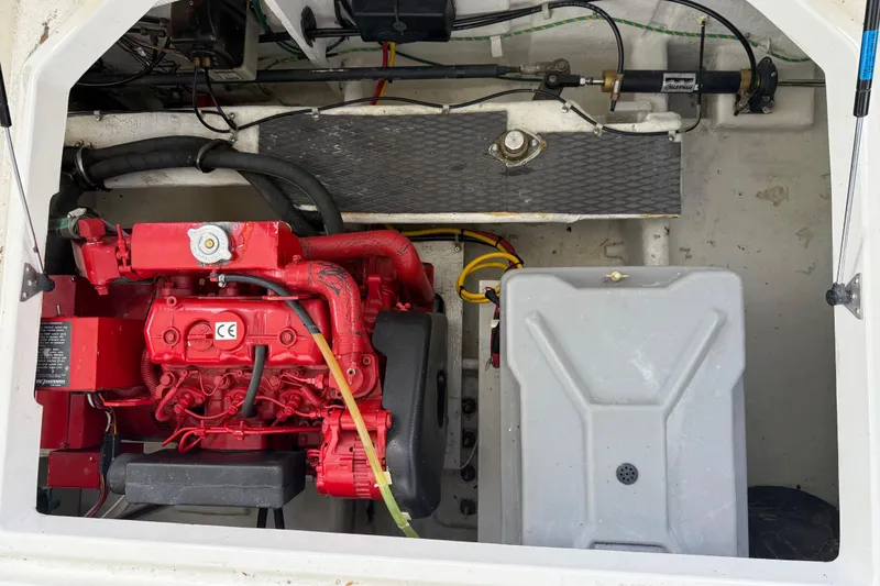 Slide: The Image of Engine compartment of a 2000 Bayliner 3988 Command Bridge Motoryacht with red engine components. - 71