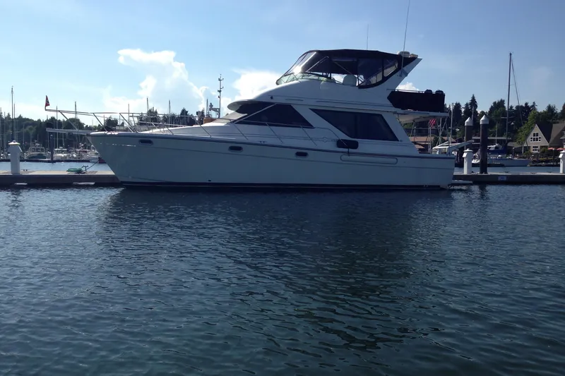 Slide: The Image of 2000 Bayliner 3988 Command Bridge Motoryacht docked at marina under clear sky. - 75