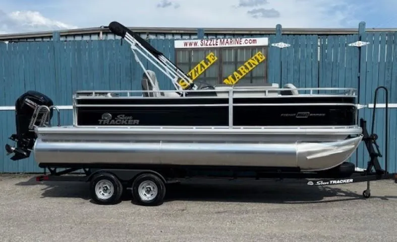 The Image of 2026 Sun Tracker Fishin' Barge 20 DLX pontoon boat on trailer, parked at Sizzle Marine. - 0