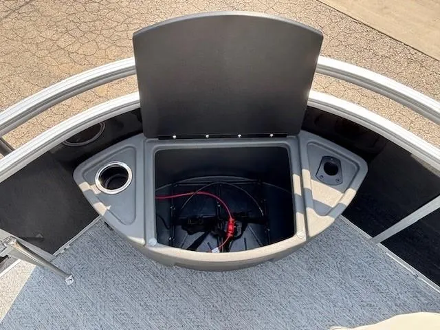 Slide: The Image of 2026 Sun Tracker Fishin' Barge 20 DLX storage compartment with cup holders and wiring. - 10