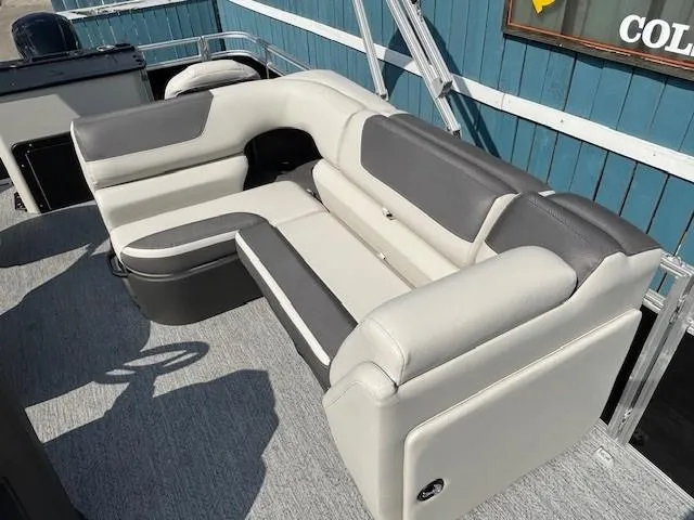 Slide: The Image of 2026 Sun Tracker Fishin' Barge 20 DLX interior seating, featuring gray and white upholstery. - 16