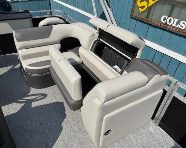 Slide: The Image of 2026 Sun Tracker Fishin' Barge 20 DLX interior with gray seating and storage compartments. - 17
