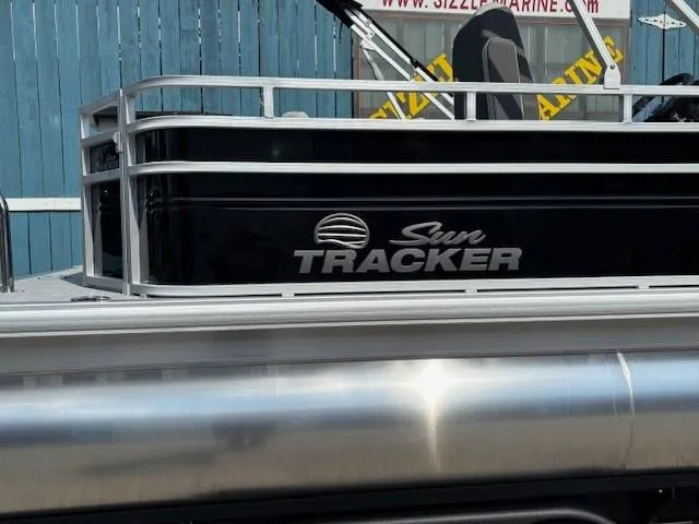 Slide: The Image of 2026 Sun Tracker Fishin' Barge 20 DLX pontoon boat, black exterior, side view. - 2