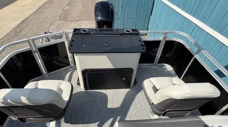 Slide: The Image of 2026 Sun Tracker Fishin' Barge 20 DLX interior with seating and control panel. - 23