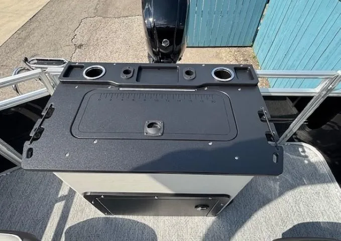 Slide: The Image of 2026 Sun Tracker Fishin' Barge 20 DLX boat console with cup holders and storage. - 25