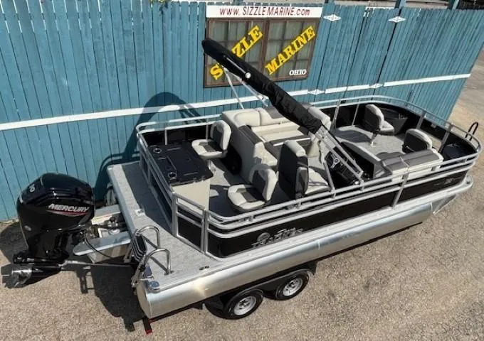 Slide: The Image of 2026 Sun Tracker Fishin' Barge 20 DLX pontoon boat with Mercury engine, parked on trailer. - 6