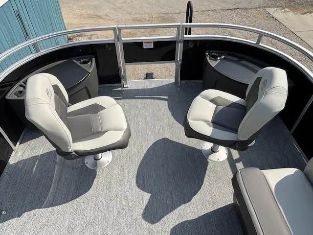 Slide: The Image of 2026 Sun Tracker Fishin' Barge 20 DLX interior with swivel seats and carpeted deck. - 8