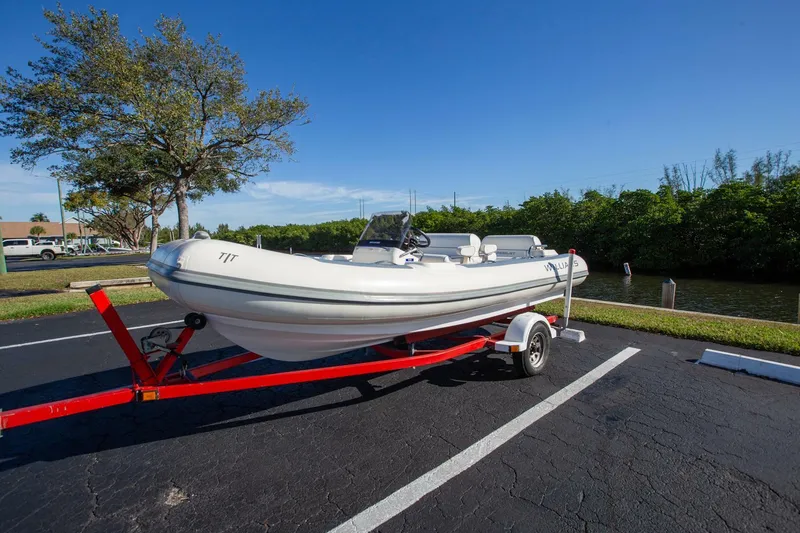 Slide: The Image of 2018 Williams Jet Tenders 505 Dieseljet on red trailer, parked near waterway. - 4