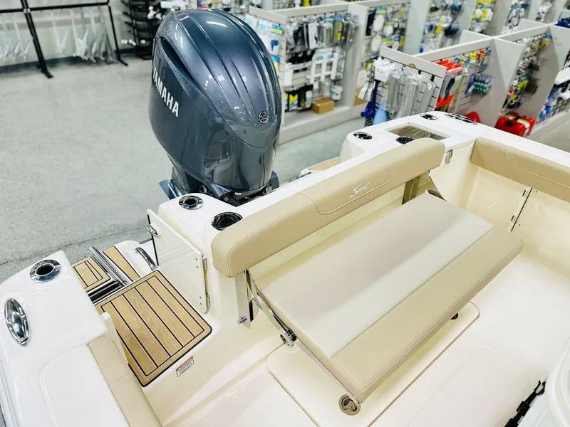 Slide: The Image of 2026 Scout 215 XSF boat interior with Yamaha engine, beige seating, and wooden accents. - 12