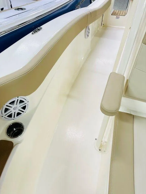 Slide: The Image of 2026 Scout 215 XSF boat interior with beige seating and speaker system. - 13