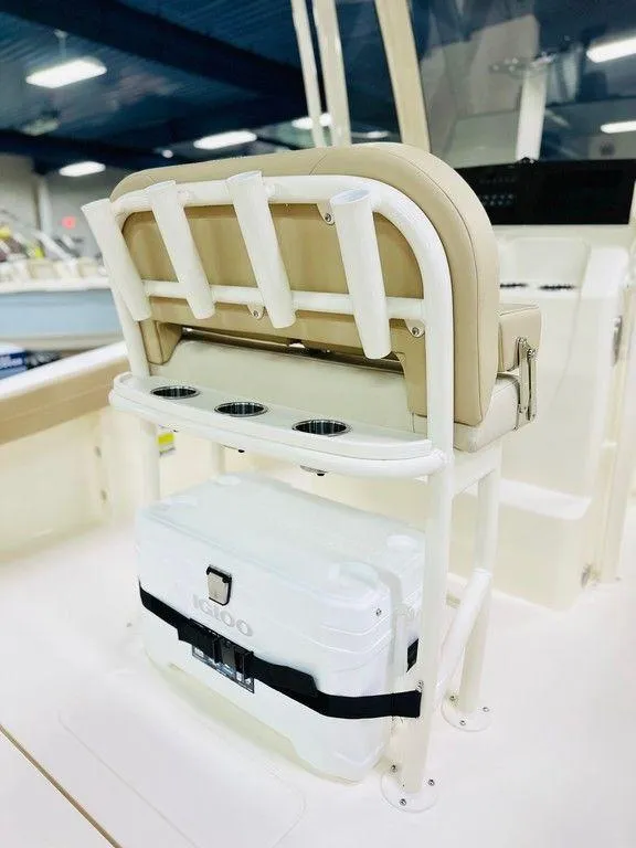 Slide: The Image of 2026 Scout 215 XSF boat seat with rod holders and cooler storage. - 7