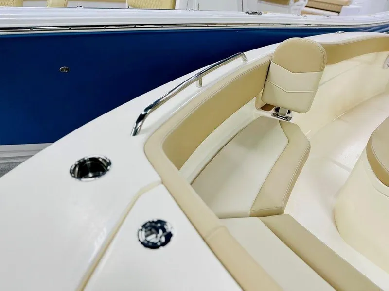 Slide: The Image of 2026 Scout 215 XSF boat interior with beige seating and blue exterior. - 9