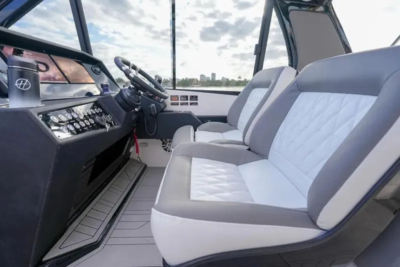 Slide: The Image of Interior of 2025 Hanover 387 boat with modern dashboard and plush seating. - 10