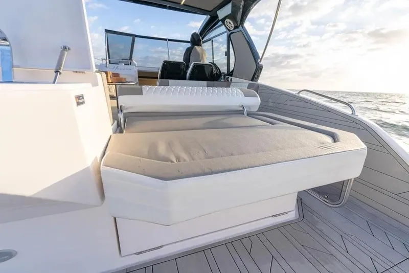 Slide: The Image of 2025 Hanover 387 boat interior with cushioned seating and ocean view. - 11